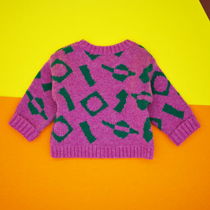 Back of children's jumper in pink and green wool jacquard.